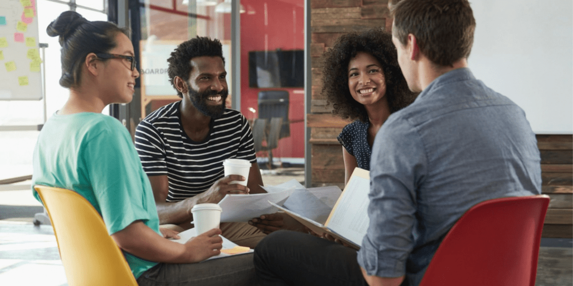Group of diverse grad school students networking and discussing at a professional association gathering