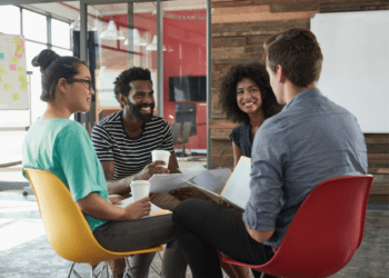 Group of diverse grad school students networking and discussing at a professional association gathering