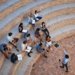 Group of college students engaged in a leadership lecture, actively participating and developing their skills in an open outdoor setting