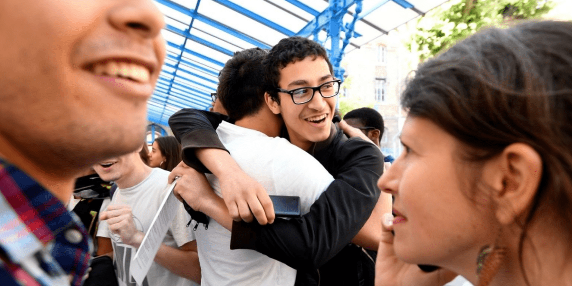 Group of smiling college students celebrating friendship and success, emphasizing the top skills needed to supercharge your freshman year.