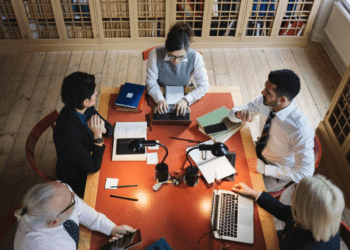 A group of smart professionals engaged in a productive discussion, representing the future-proof professions that are resilient to AI advancements for the next 30 years.