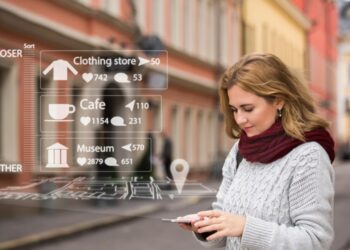 Woman engaging with a mobile phone, representing the digital trends driving brand engagement.