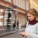 Woman engaging with a mobile phone, representing the digital trends driving brand engagement.