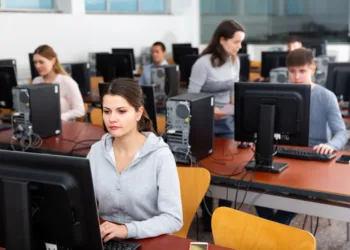 Computer Science students working in a lab on their desktop computers, representing the enduring popularity of the field despite IT industry challenges.