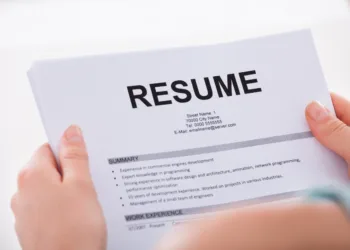 Professor holding resume - showcasing the importance of a well-prepared resume for internship and summer program applications.