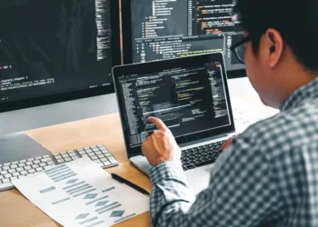 Dedicated male intern immersed in coding on his laptop, representing the tech internship experience.