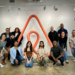 Group of interns taking a group photo in the Airbnb office during an internship program.